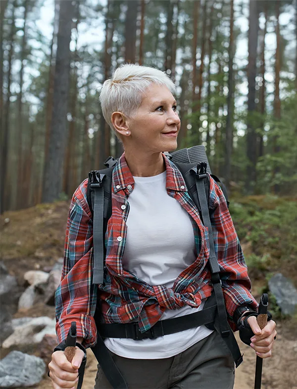 senior woman hiking in woods