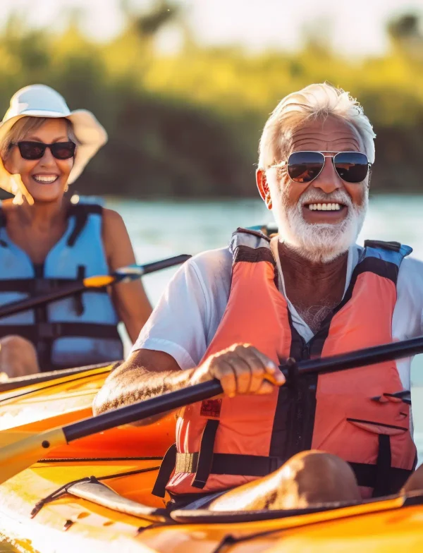an elderly man with friends, families, kayaking on the water