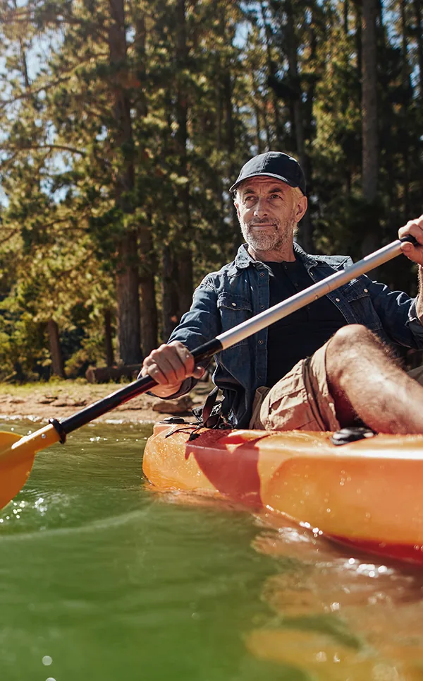 senior man kayaking on the lake