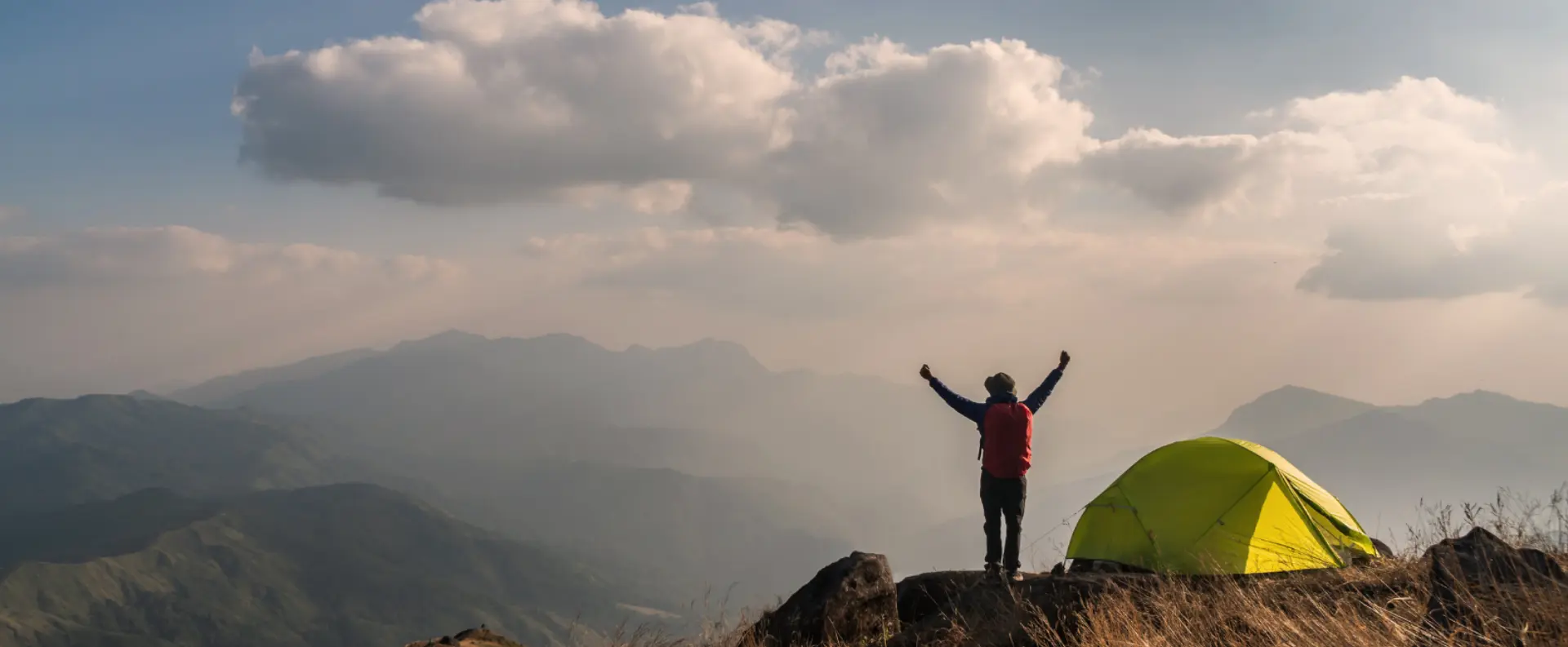 Young man traveler with backpack camping
