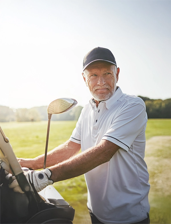 mature male golfer grabbing clubs