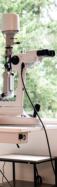 Exam room with slit lamp and phoropter machine at Rudd Vision