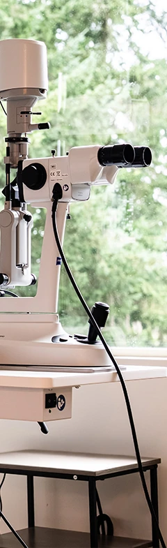 Exam room with slit lamp and phoropter machine at Rudd Vision